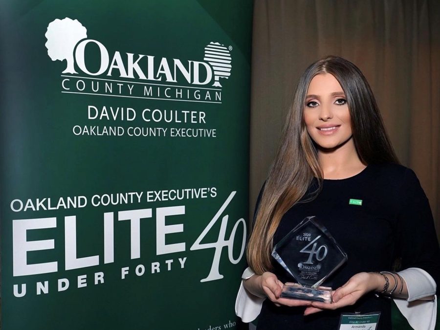 Co-owner Armanda Prendushi-Hadribeaj accepting the Oakland County Executive's Elite 40 Under 40 award